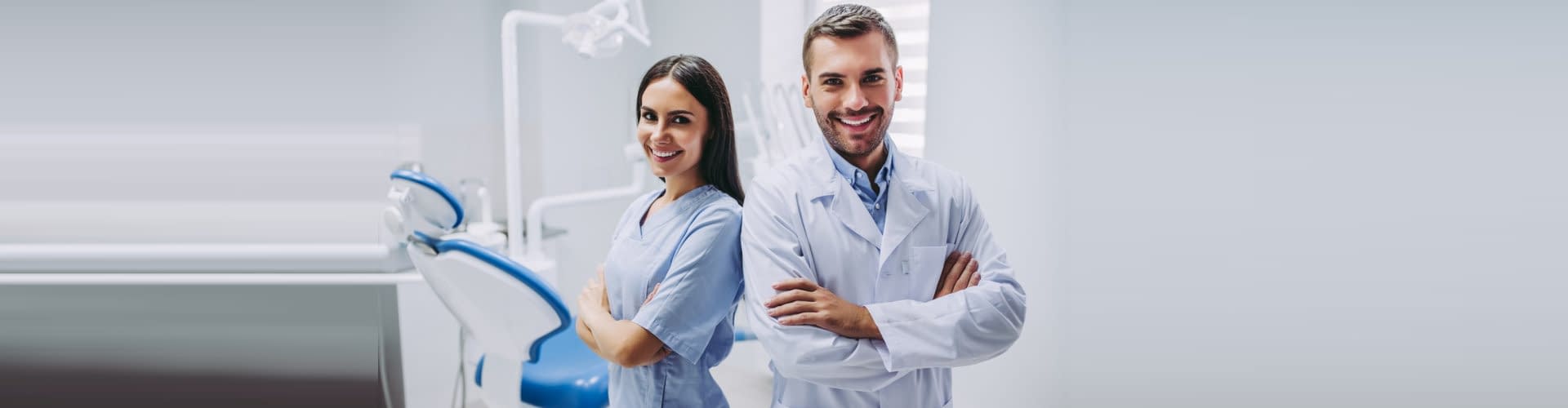 smiling doctor and assistant with crossed hands